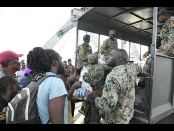 Members of the Jamaica Defence Force hand out care packages to residents of Crane Road in St Elizabeth, following the destructive passage of Hurricane Melissa on October 28, 2025. 