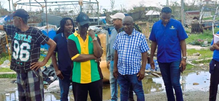 Minister of Local Government, Desmond McKenzie (2nd left) and Mayor of Falmouth, Collen Gager (right front) tour the town of Falmouth with other technocrats in the government and vendors displaced by Hurricane Melissa.