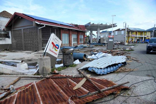 
A TotalEnergies sign sits amid rubble on Market Street in Falmouth, Trewlany, on Wednesday, October 29, 2025 after the passage of Hurricane Melissa, which swept through Jamaica on October 28.