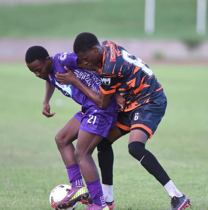 Robinho Morgan (left) of Kingston College and Horace Morgan of Tivoli High battle for the ball during their ISSA-WATA Manning Cup football match at the Stadium East field on on Wednesday, October 1. KC won 4-0.