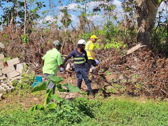 Local Government and Community Development Minister Desmond McKenzie (left) leading a clean-up session at the St Elizabeth Infirmary on Thursday.