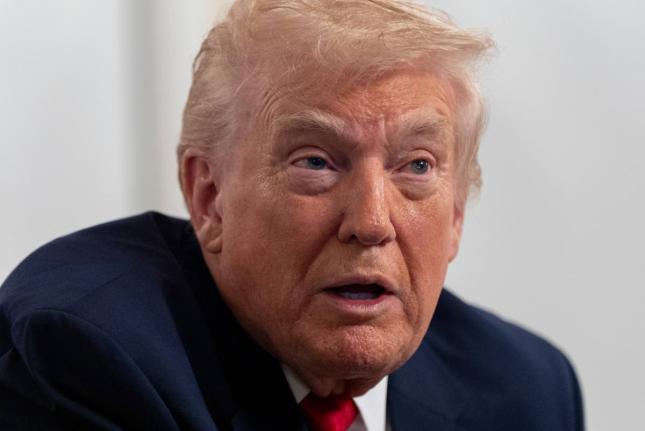 President Donald Trump speaks to reporters after speaking to troops via video from his Mar-a-Lago estate on Thanksgiving, Thursday, November 27, 2025, in Palm Beach, Florida. (AP Photo/Alex Brandon)