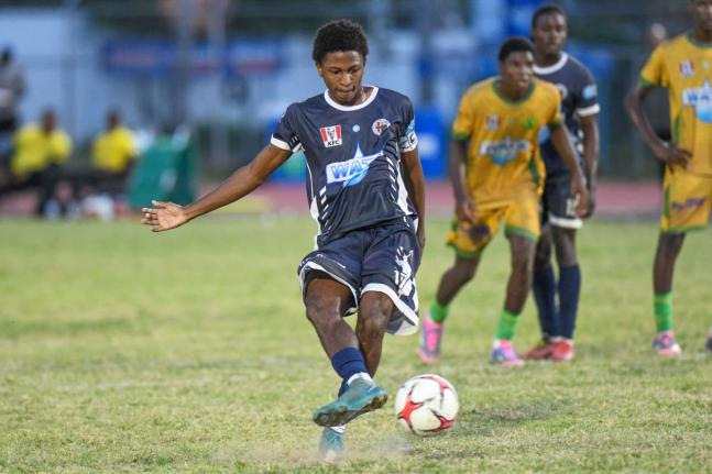 Jamaica College’s Dontae Logan scores from the penalty spot during yesterday’s Manning Cup match against St Jago High at Ashenheim Stadium. Jamaica College won 2-1.