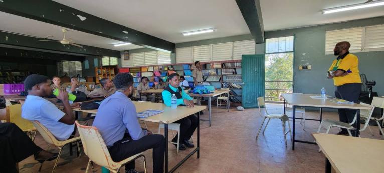 Michael McPherson (right) speaks with mentors and mentees at Calabar High School.