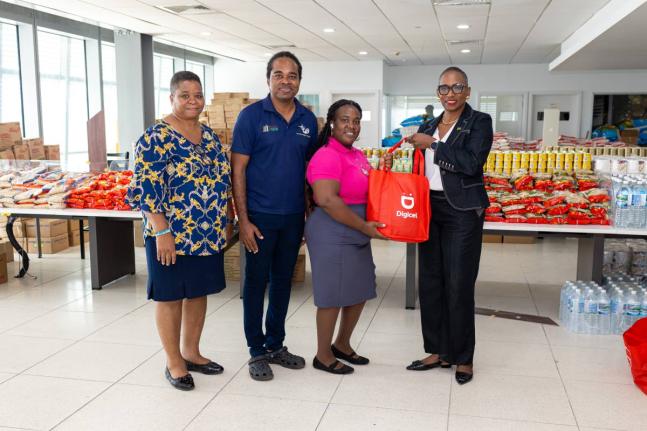 Digicel Foundation Chair, Joy Clark (right), presents a relief care package to representatives from Ready to Sign, Deaf Sports Jamaica, and the Jamaica Deaf Youth Advocacy as part of their donation drive to support members of the deaf community with much-n