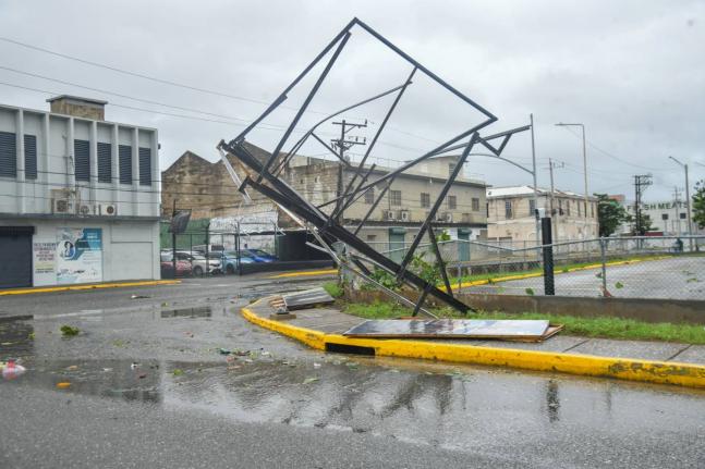 In the midst of Hurricane Melissa, a broken billboard stand is seen at the intersection of Port Royal Street and Ocean Boulevard in Kingston, on October 28, 2025.