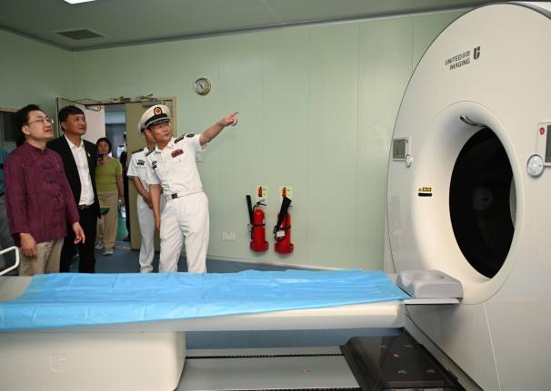 From left: Ambassador of the People’s Republic of China to Jamaica, Wang Jinfeng; Ziping Chen, chairman of the Fujian Association of Jamaica; and Li Min, crew member of ‘Ark Silk Road’ medical ship viewing a CT scan machine during a tour of the vesse
