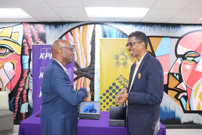 Raymond Campbell (left), 0ffice manager partner at KPMG in Jamaica and country leader for KPMG in CARICOM, shares a light moment with Ian Neita, chair of Project STAR’s Management, Monitoring and Reporting Committee, during the handover of 40 laptops to 