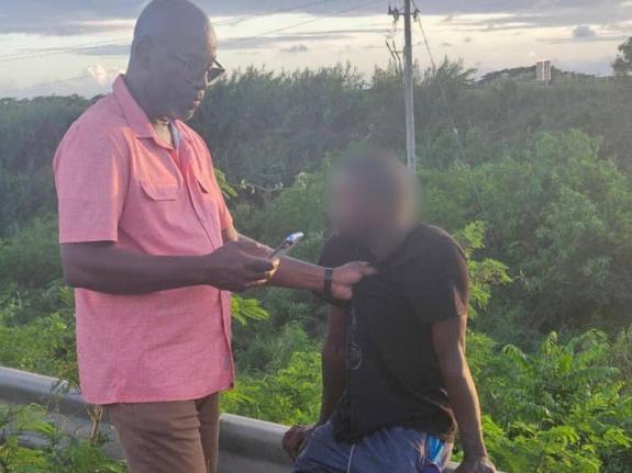 Councillor Scean Barnswell (left) detains the man who allegedly abducted a six-year-old girl in Clarendon on December 9, 2025.