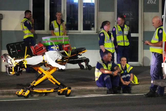 Emergency workers standby at Bondi Beach after a reported shooting in Sydney, Australia on December 14, 2025. 