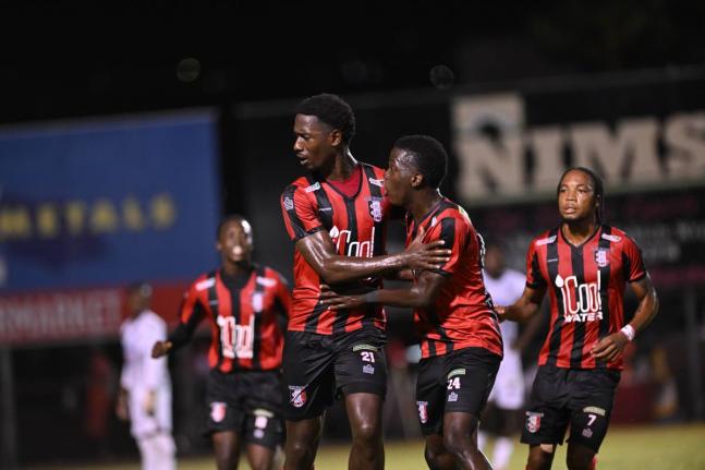 Members of the Arnett Gardens FC team celebrate a goal against Cavalier at the Anthony Spaulding Sports Complex during the 2024-25 Jamaica Premier League season.