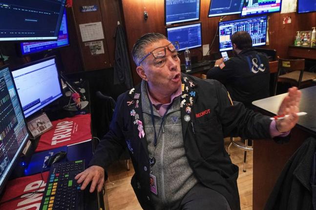 Trader Jonathan Mueller works on the floor of the New York Stock Exchange, Thursday, December 11, 2025. 