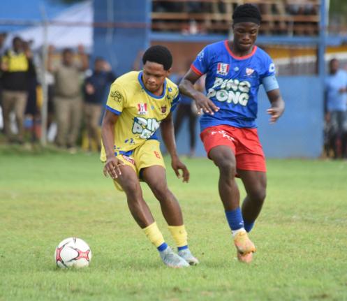 St Elizabeth Technical High School’s Jade Lynch (left) tries to shake off the attention of Kemps Hill High School’s Shemar Daley during a testy round-of-16 ISSA daCosta Cup clash at STETHS Sports Complex on October 22.