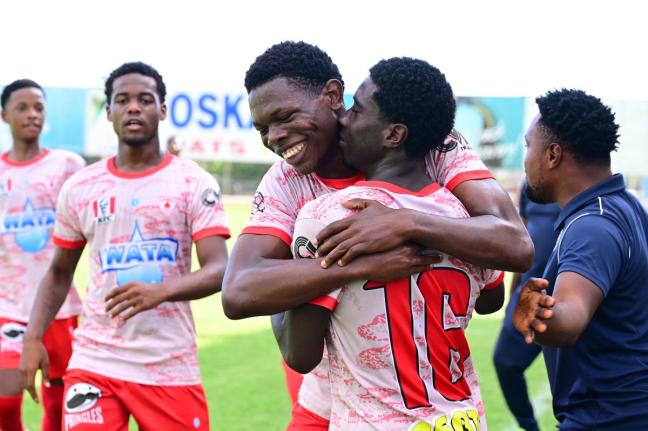 Mona High School’s Franklyn Mitcham (centre) celebrates scoring in a Walker Cup semi-final against Charlie Smith High School at the Anthony Spaulding Sports Complex yesterday.