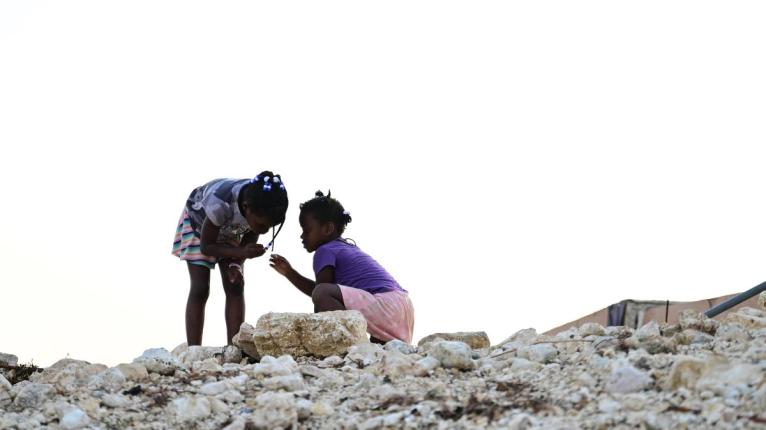 Children play amid the rubble on High Street, Black River, St Elizabeth, following the passage of Hurricane Melissa in October.