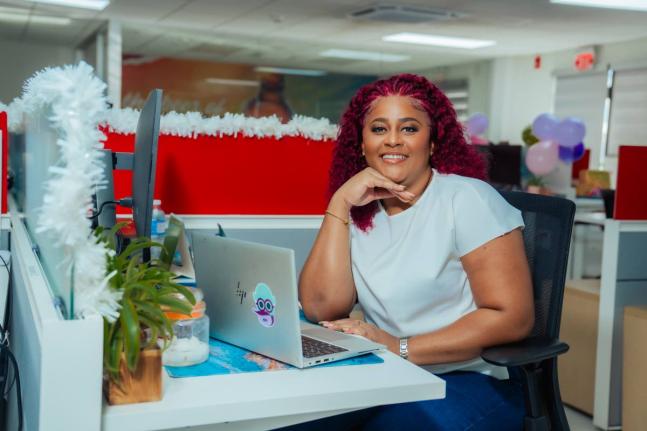 Alisha Distant paused from her work at her desk for a quick photo op.