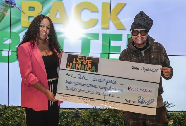 Music executive, Portia Clarke-Mellanaise and reggae and R&B star, Maxi Priest, display a symbolic cheque made out to the JN Foundation to assist in its Hurricane Melissa relief efforts. The funds were raised through the staging of the ‘For the Love of J