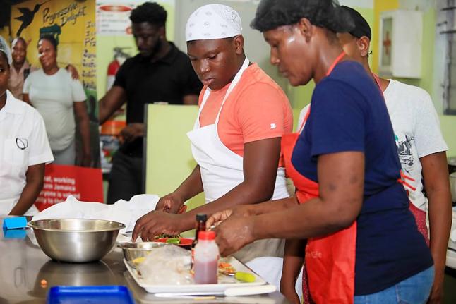 Participants stay focused as they prepare nutritious, family-friendly meals during the Parenting Club cook-off, balancing creativity, affordability and healthy eating.