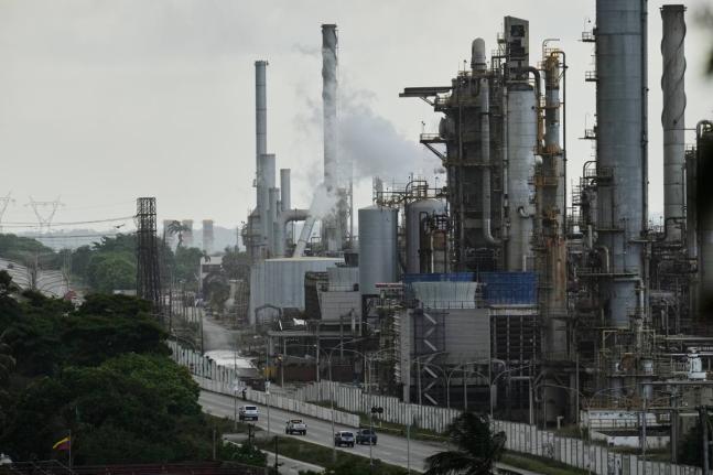 Vehicles drive past the El Palito refinery in Puerto Cabello, Venezuela, on December 21, 2025.