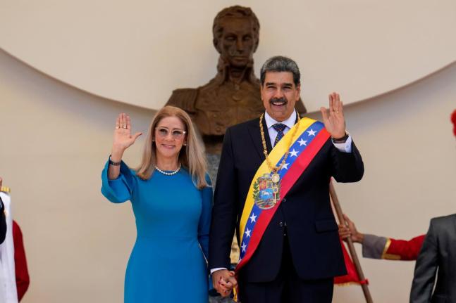 Venezuelan President Nicolas Maduro and his wife Cilia Flores wave after his swearing-in ceremony for a third term at the National Assembly in Caracas, Venezuela, Friday, January 10, 2025. (AP Photo/Ariana Cubillos)