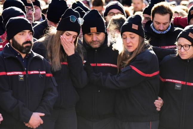Firefighters cry as they attend a memorial march in Crans-Montana, Swiss Alps, Switzerland, to honour victims of devastating fire in Le Constellation bar.