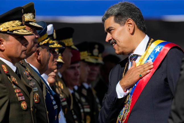 Venezuela's President Nicolas Maduro places his hand over his heart while talking to high-ranking officers during a military ceremony on his inauguration day for a third term, in Caracas, Venezuela on January 10, 2025. The US captured him in Venezuela on J