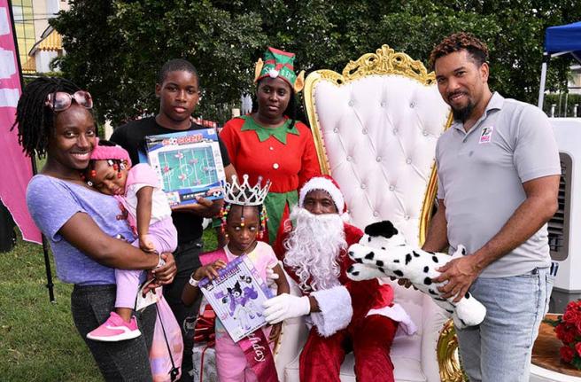 Media relations officer at the Jamaica Tourist Board (JTB) Christopher Burke (right) assists Santa and his elf in handing out gifts to attendees at the JTB’s recent Christmas Treat, held at Devon House in Kingston. The event, held for tourism workers and