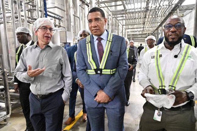 Sheldon Sharpe, (right) Business Unit Manager at Wisynco, and Andrew Mahfood, (left) CEO of Wisynco Group, explain how its new plant works to Prime Minister Dr Andrew Holness during at tour of the facility in Lakes Pen, St Catherine on Tuesday, January 13,