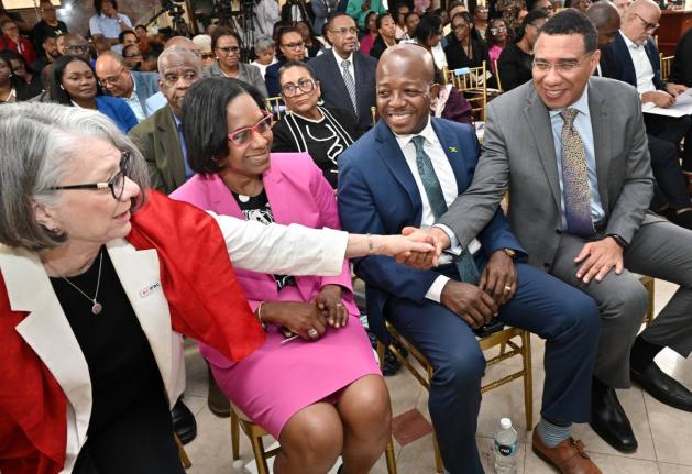 Prime Minister Dr Andrew Holness (right) greets Kate Forbes (left), president of the International Federation of Red Cross and Red Crescent Societies, while looking on are Dionne Jennings, permanent secretary in the Ministry of Labour and Social Security, 