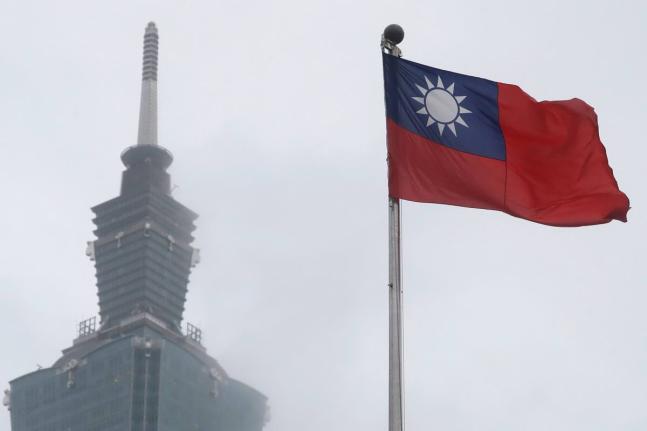 A Taiwan national flag flutters near the Taipei 101 building at the National Dr. Sun Yat-Sen Memorial Hall in Taipei.
