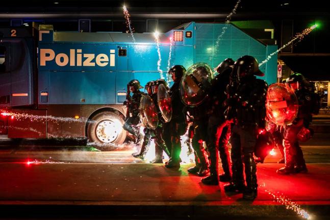 Riot police clash with protesters after a rally against the World Economic Forum in Davos and the visit of US President Donald Trump, on Monday, in Zurich, Switzerland, January 19, 2026. 