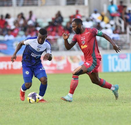 Montego Bay United Football Club’s captain Owayne Gordon (right) moves in to tackle Franco Celestin of Mount Pleasant Football Academy during their Jamaica Premier League football semi-final at Sabina Park on Sunday, May 18, 2025.