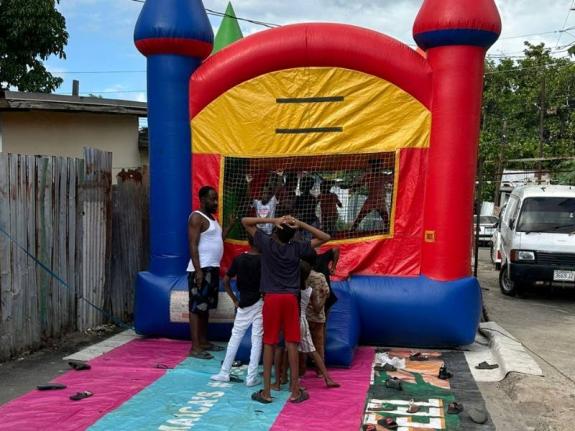 Children enjoy a bounce-about during the Waltham Park Police Post’s 'Christmas in January' community outreach event for residents of 75 and 77 Lanes in St Andrew on January 24 2026. The initiative forms part of efforts to rebuild trust and promote unity 