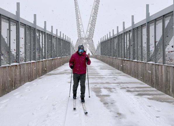 Jacob Coleman skis across SkyDance Bridge over Interstate 40 during a snowstorm in Oklahoma City on January 24, 2026.