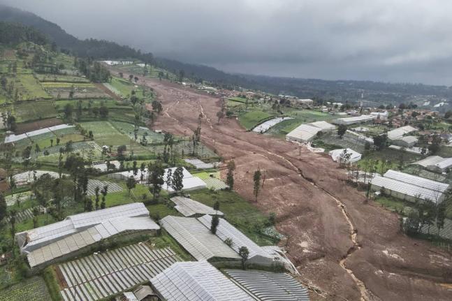 In this photo released by the Indonesian National Search and Rescue Agency, an aerial shot taken using a drone shows an area affected by landslides in Pasir Langu village, in West Bandung district of West Java province, Indonesia.