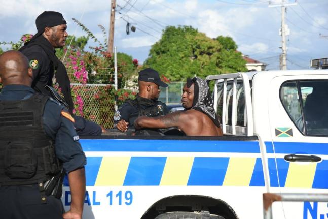 US-based Reggae Boy Cory Burke is taken away by members of the Jamaica Constabulary Force outside the Ferdi Neita Park in Portmore, St Catherine on January 25, 2026. 