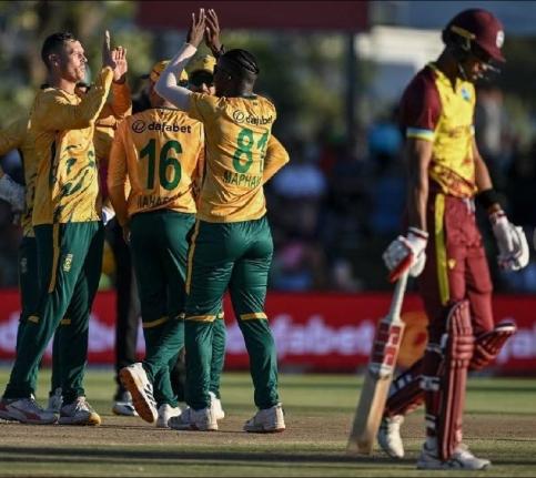 South African players celebrate the wicket of West Indies captain Roston Chase during the first T20I in Paarl, South Africa, yesterday.