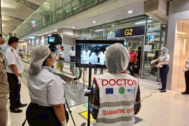 In this photograph provided by the public relations department of the Suvarnabhumi International Airport, Quarantine doctors watch thermal scanning of travellers from west Bengal, India at the Suvarnabhumi International Airport in Samut Prakarn, Thailand, 
