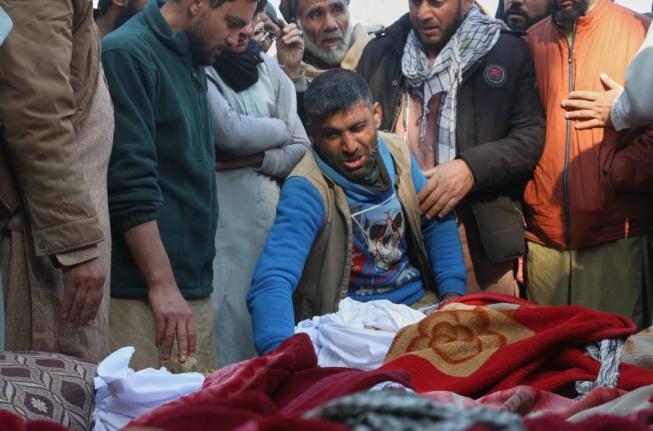 A grieving man reacts as relatives gather around the bodies of victims of a house collapse during a funeral procession in Jalalabad, Afghanistan, Thursday, January 29, 2026. 