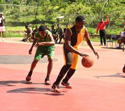 York Castle High’s Omar Campbell (right) dribbles away from  Belair High’s Raheem Irvin during their ISSA Rural Schoolboys Basketball match at York Castle’s court on Wednesday, January 28, 2026.