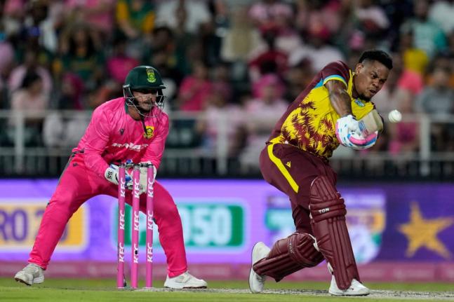 
West Indies batsman Shimron Hetmyer (right) plays a shot as South Africa’s wicketkeeper Quinton de Kock watches on during the final T20 International in Johannesburg, South Africa, yesterday. The West Indies won by six runs.