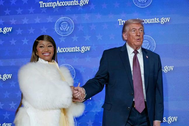 Nicki Minaj and US President Donald Trump stand on stage together during an event for ‘Trump Accounts’ at Carnegie Mellon Auditorium, in Washington DC. 