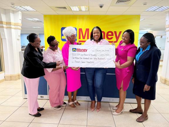 Sanya Wallace-Innerarity (third right), assistant general manager for strategy, marketing, and sales at JN Money, presents a symbolic cheque to Sandra Samuels (third left), president of Jamaica Reach to Recovery (JR2R), and Roshane Reid-Koomson (second rig