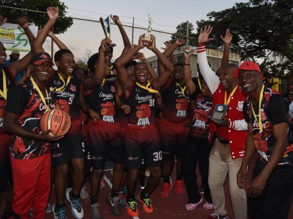 Members of the Campion College ISSA Urban Schoolboys Under-19 basketball team celebrate after they were presented with the championship trophy at the school yesterday.
