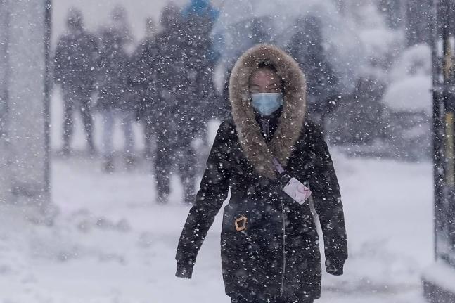 A man walks along the Hudson River Greenway in lower Manhattan during a snow storm, on February 23, 2026, in New York. 