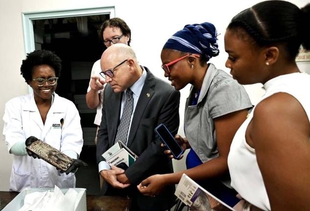 Members of the US Embassy team (3rd left – right), Public Affairs Attaché Mike Lavallee, Resource Coordinator, Kimberly-Joe Osborne and Resource Coordination Assistant, Monique Lindsay-Armstrong, look at a 17th-century Port Royal artefact displayed by K
