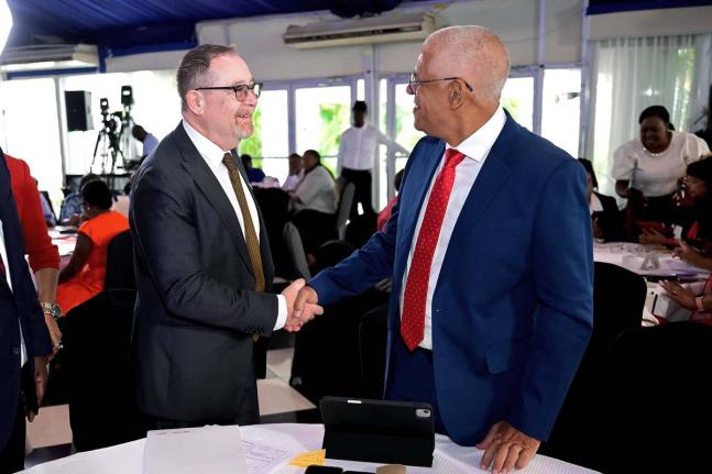 Canada’s High Commissioner to Jamaica, Mark Berman (left), greets portfolio manager for the Caribbean Development Bank (CDB) Basic Needs Trust Fund, George Yearwood, during the opening ceremony for the inaugural Caribbean Civil Society Organisation (CSO)