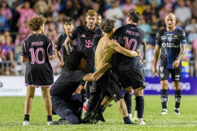 A fan (centre) got onto the field and grabbed Inter Miami’s Lionel Messi during an international friendly  match against Ecuador’s Independiente del Valle in Bayamon, Puerto Rico, on Thursday night.