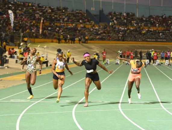 
Jonielle Smith (second right) outdips Tina Clayton (second left) during the Gibson McCook Relays 60-metre invitational women’s event at the National Stadium yesterday.