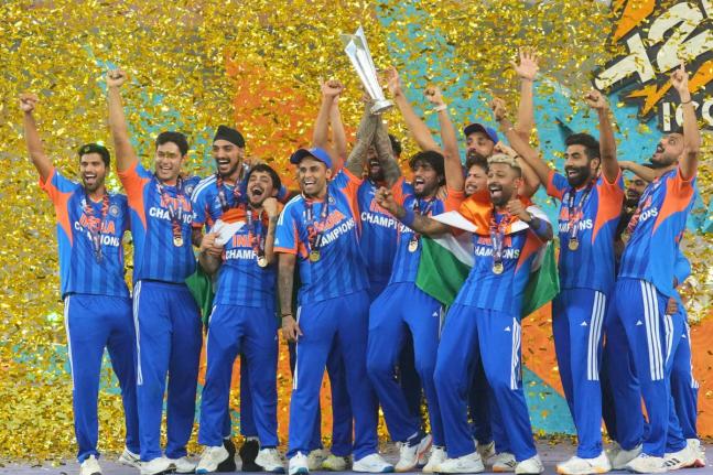 India's players celebrate with the trophy after winning the T20 World Cup final match against New Zealand, in Ahmedabad, India, Sunday, March 8, 2026. (AP Photo/Rafiq Maqbool)